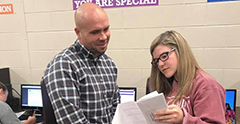 Financial Aid Director assisting student.