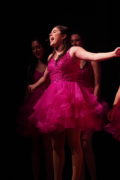 Show Choir - Girl singing in in pink dress.