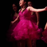 Show Choir - Girl singing in in pink dress.