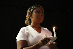Wallace nursing graduate holding lighted candle at the spring 2025 pinning ceremony