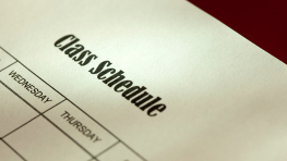 A close-up photo of a printed class schedule with the bold title ‘Class Schedule’ at the top, and a partially visible grid showing days of the week, including Wednesday and Thursday.