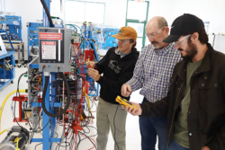 Students working with instruction in the industrial systems lab on Sparks Campus