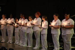 Spring 2026 ADN nursing graduates during the candle lighting ceremony
